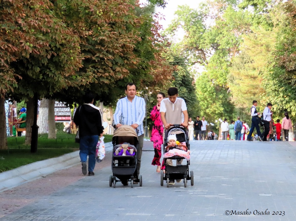 Young fathers pushing a pram. Samarkand, Uzbekistan